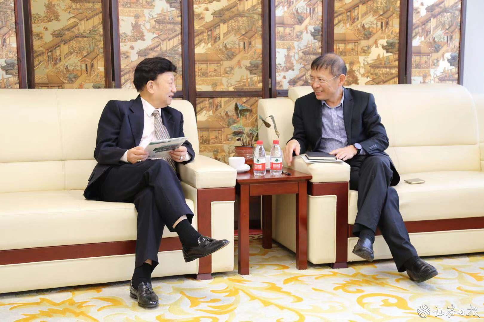華僑國際樓宇黨委書記、總裁孔村光（右）與美中貿易發展協會總裁、執行長姚應文博士（左）進行商務洽談.jpg